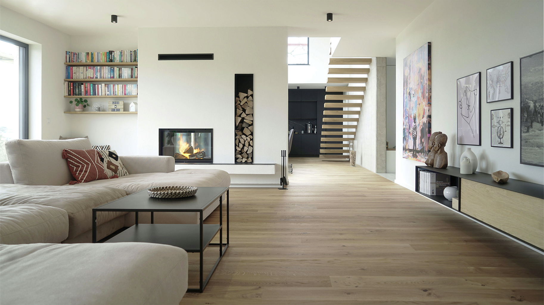 Helles Wohnzimmer mit modernem Kamin, offener Treppe und individuell abgestimmtem Wohnkonzept